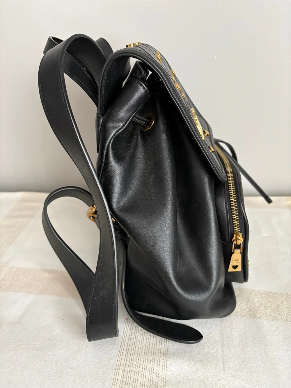 BNWOT Designer LOVE MOSCHINO Backpack, Faux Leather, with gold metal design.